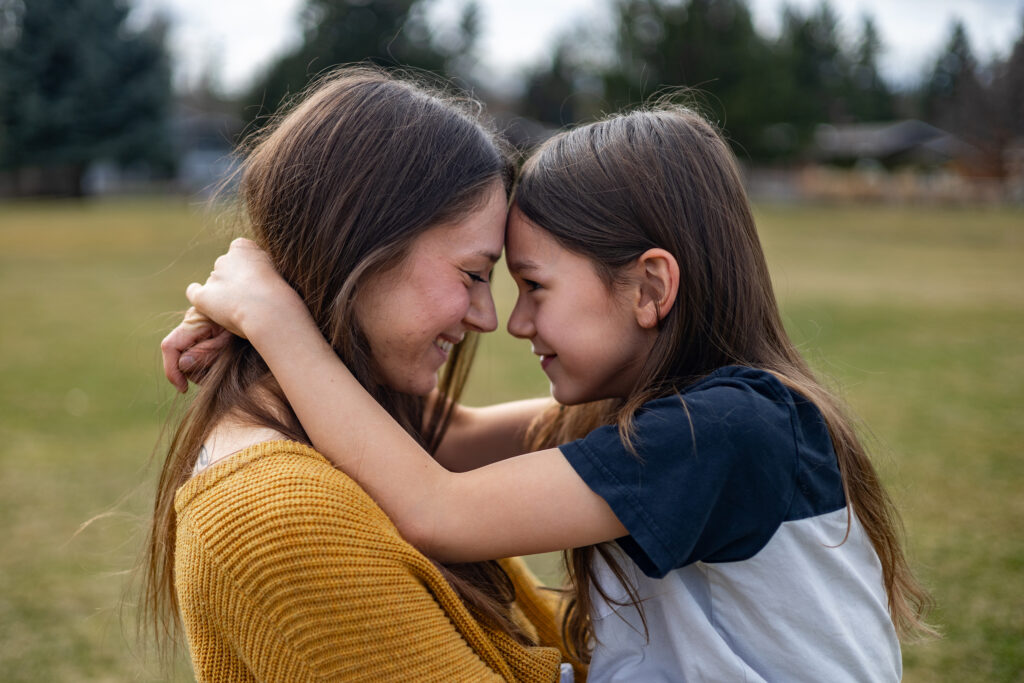Kailey and her son Kason touch foreheads, smiling and holding each other's gaze.